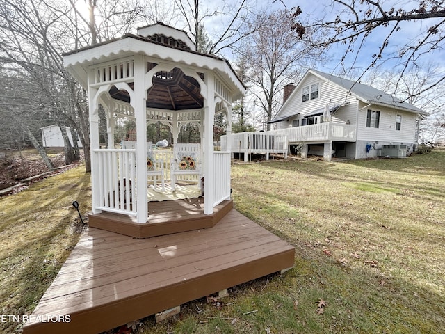 wooden terrace with a gazebo, central air condition unit, and a lawn