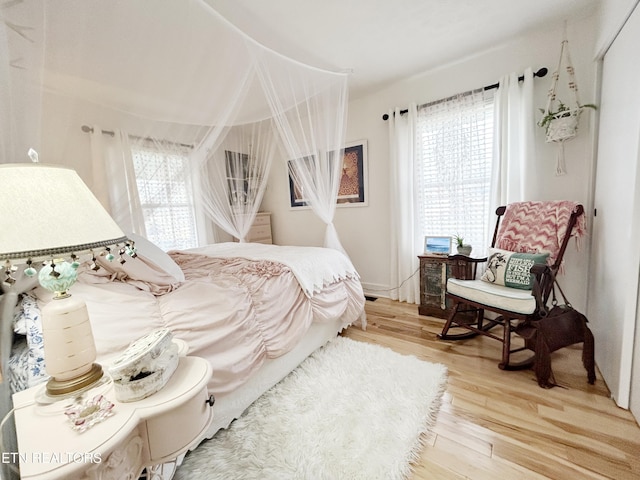 bedroom featuring wood-type flooring and multiple windows