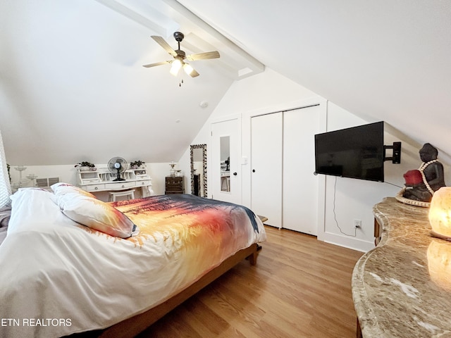 bedroom with vaulted ceiling with beams, ceiling fan, light hardwood / wood-style floors, and a closet