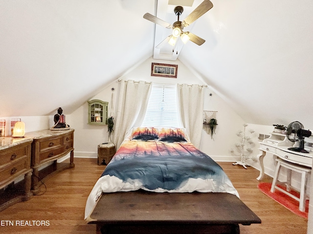 bedroom with hardwood / wood-style floors, ceiling fan, and vaulted ceiling