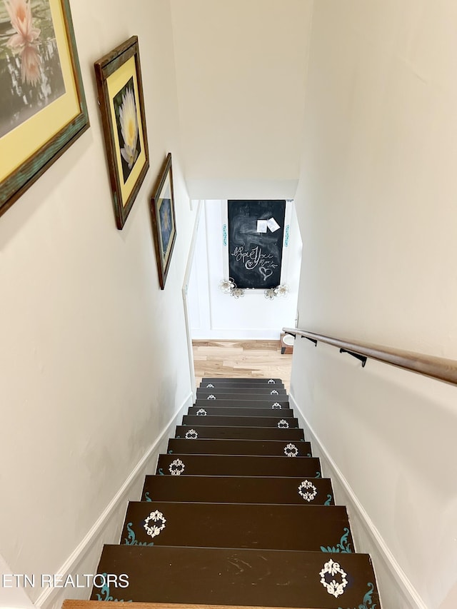 stairway featuring hardwood / wood-style floors