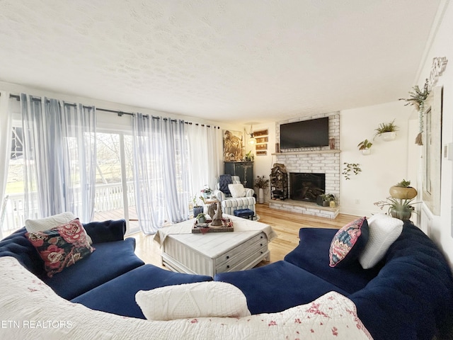 living room with a fireplace, a textured ceiling, and hardwood / wood-style flooring