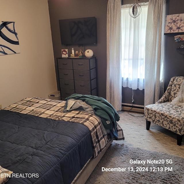 bedroom with carpet and a baseboard radiator