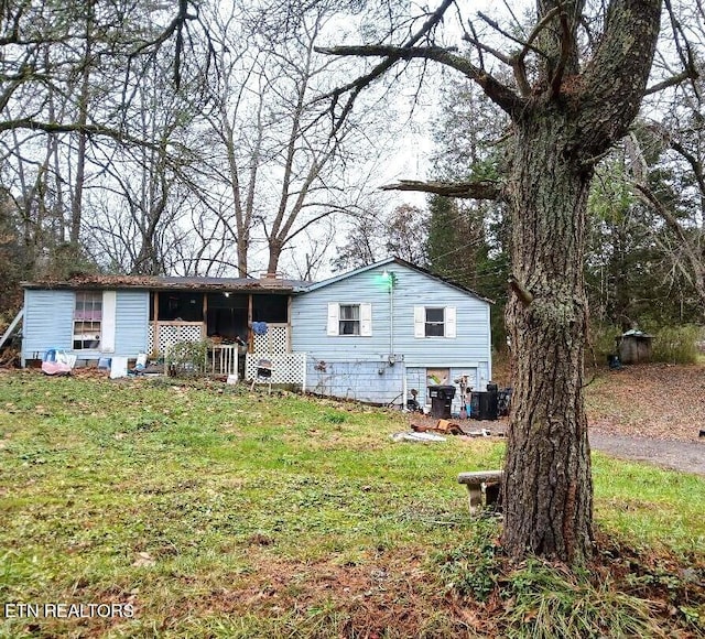 back of property with a lawn