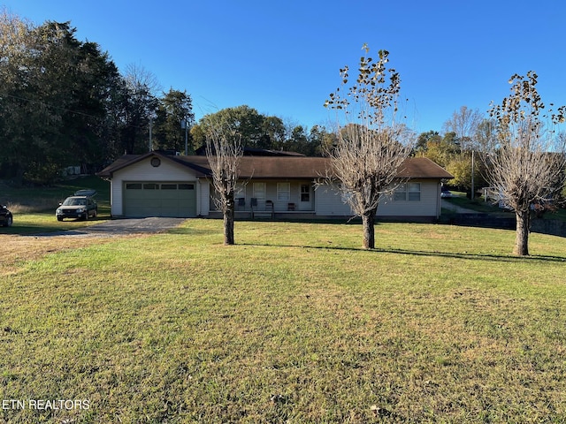 ranch-style home with a front yard and a garage