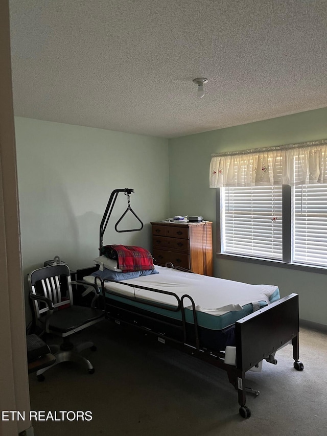 carpeted bedroom featuring a textured ceiling