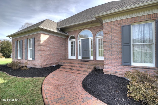 entrance to property featuring a yard