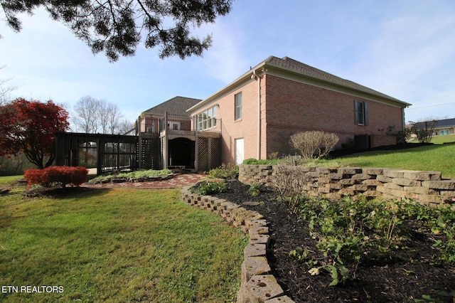 view of home's exterior with a yard and a deck