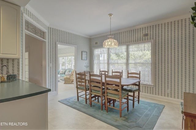 dining area with a healthy amount of sunlight, a notable chandelier, and ornamental molding