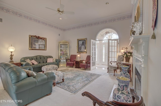 living room with carpet, french doors, ornamental molding, ceiling fan, and a premium fireplace