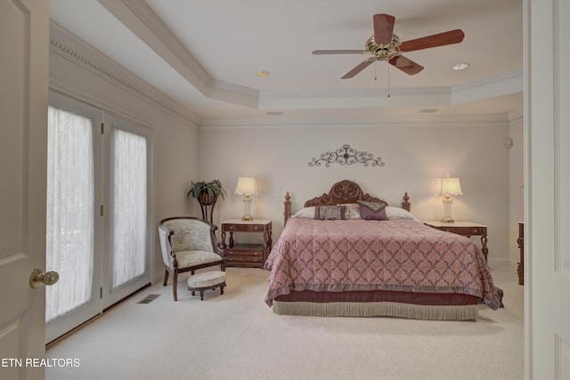 carpeted bedroom with access to outside, crown molding, a tray ceiling, and ceiling fan