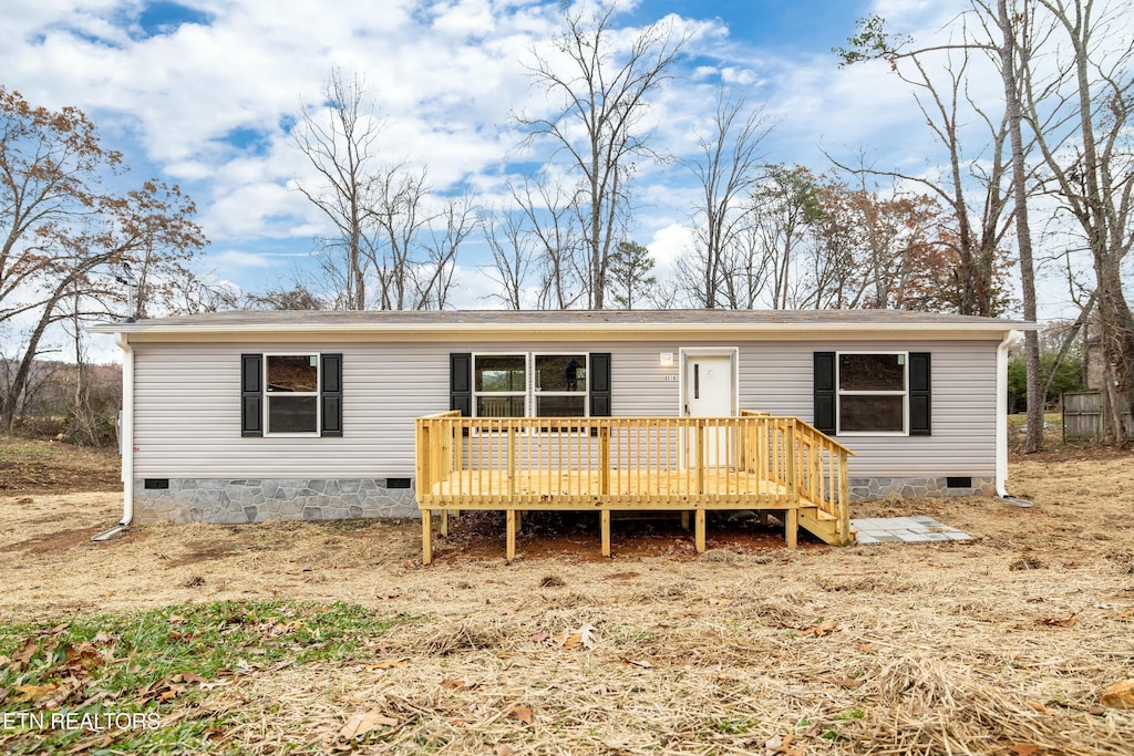 back of house with a wooden deck