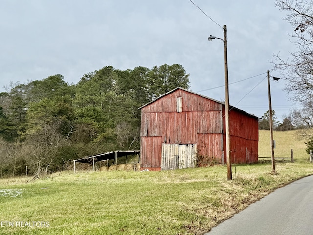 view of outbuilding featuring a lawn