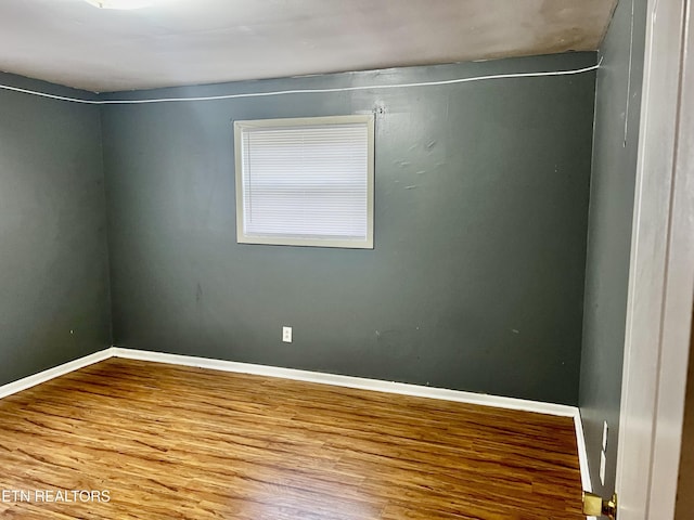 spare room with hardwood / wood-style flooring