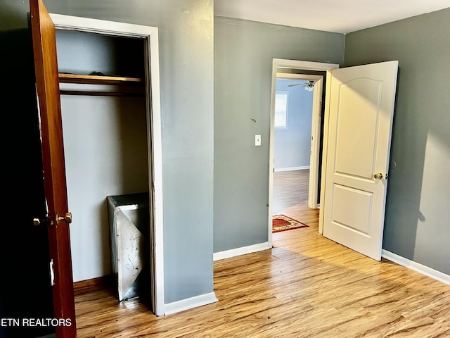 unfurnished bedroom with light hardwood / wood-style floors and a closet