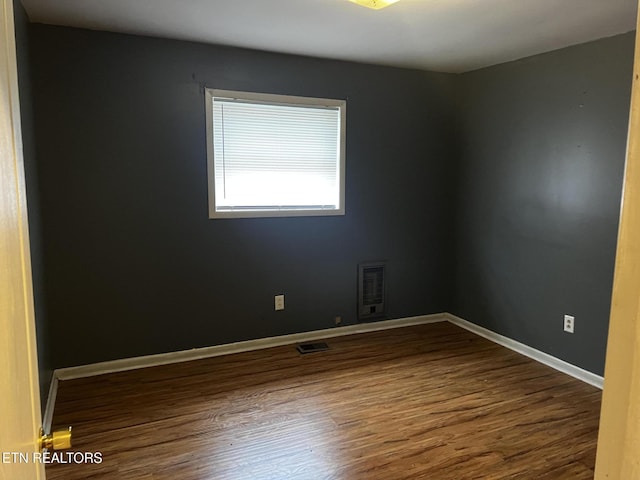 spare room featuring hardwood / wood-style floors