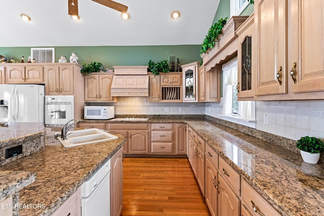 kitchen featuring vaulted ceiling, sink, white appliances, and light brown cabinets