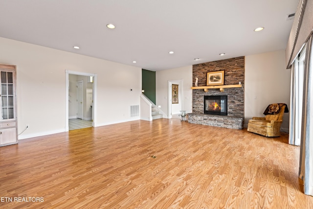 unfurnished living room featuring a fireplace and light hardwood / wood-style flooring