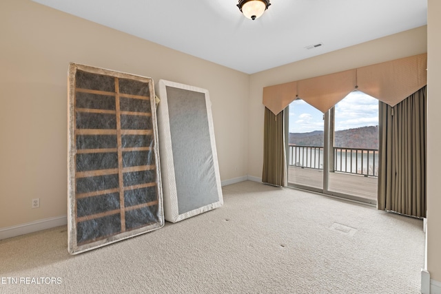 carpeted spare room with a mountain view