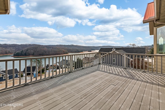 wooden terrace featuring a water view