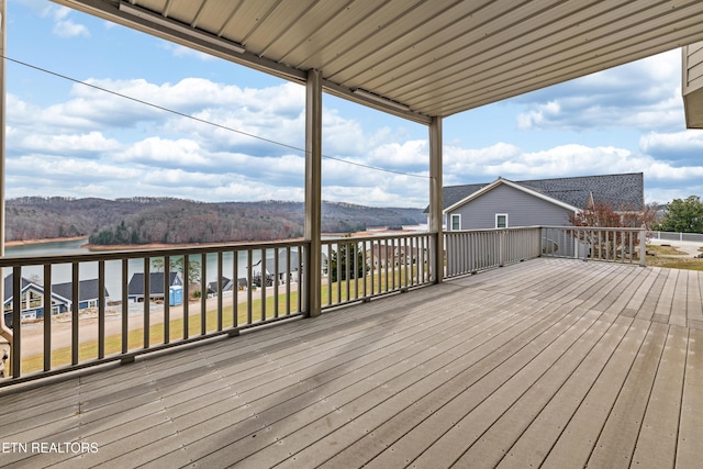 wooden deck featuring a water and mountain view