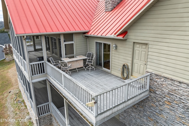 wooden deck featuring a sunroom