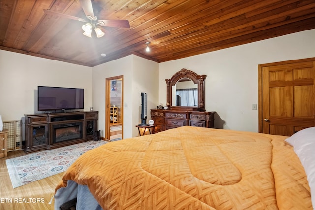 bedroom featuring hardwood / wood-style flooring, ceiling fan, and wood ceiling