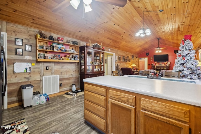 kitchen with wooden ceiling, dark wood-type flooring, lofted ceiling, and wood walls