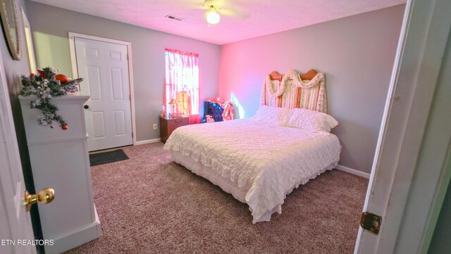 carpeted bedroom with ceiling fan