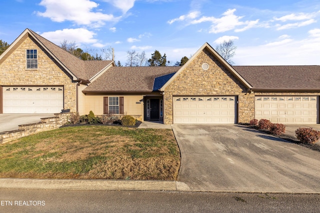 view of property featuring a front lawn and a garage