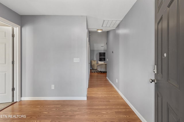 hall with light hardwood / wood-style flooring