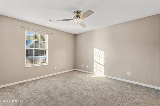 carpeted empty room featuring ceiling fan