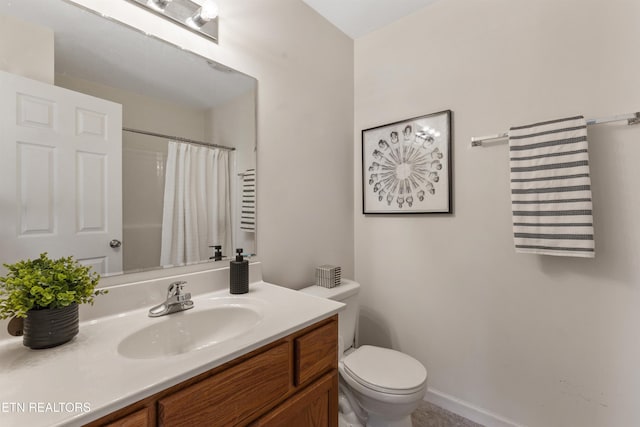 bathroom with toilet, vanity, and a shower with curtain