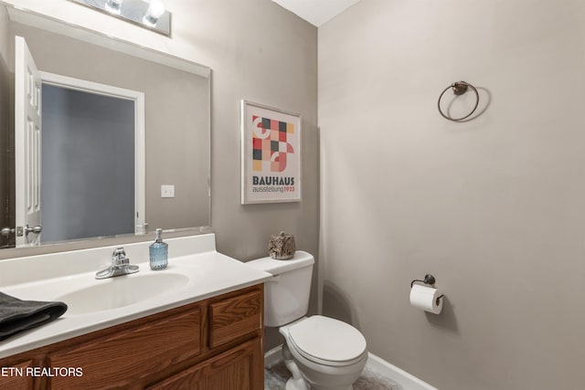 bathroom featuring toilet and vanity