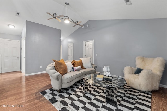 living room featuring vaulted ceiling, ceiling fan, and hardwood / wood-style floors