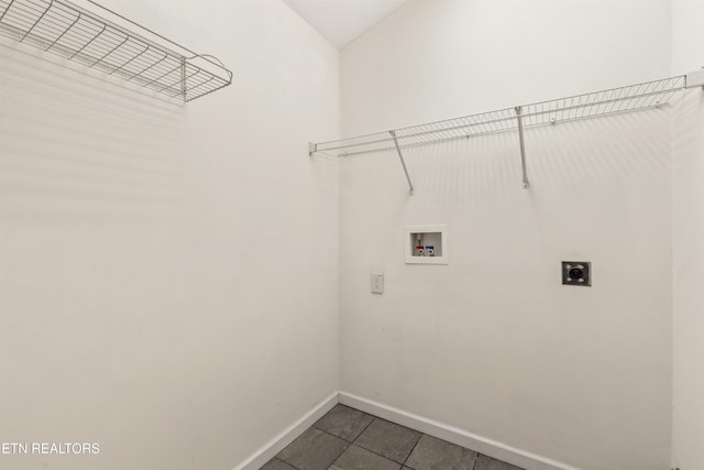 laundry area featuring hookup for a washing machine, dark tile patterned flooring, and electric dryer hookup