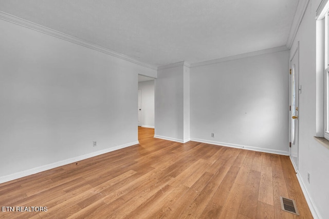 unfurnished room with crown molding and light hardwood / wood-style flooring