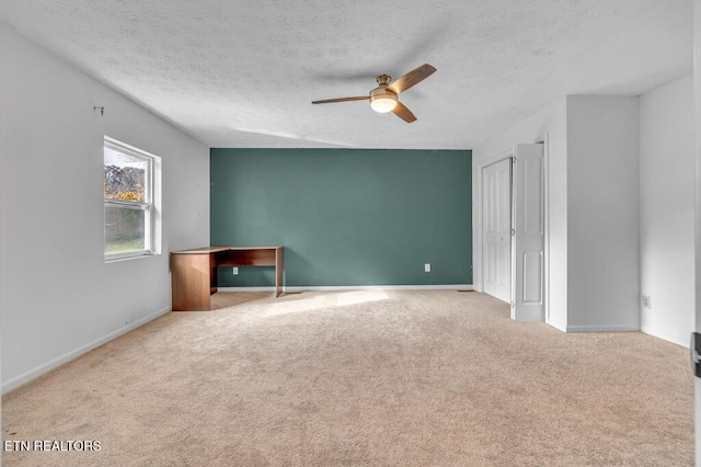 carpeted spare room with ceiling fan and a textured ceiling