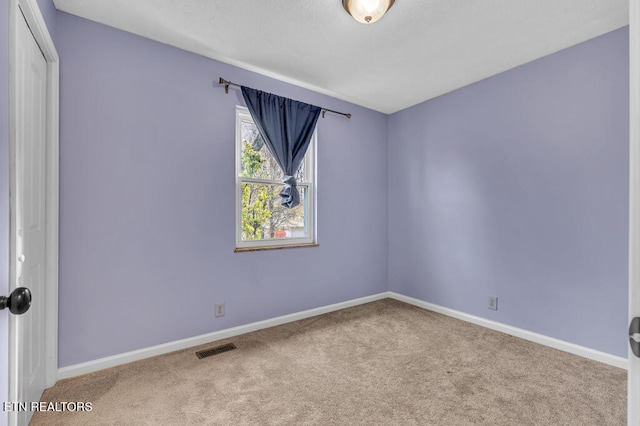 unfurnished room featuring carpet flooring