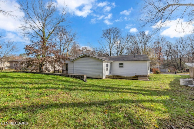 rear view of house with a lawn