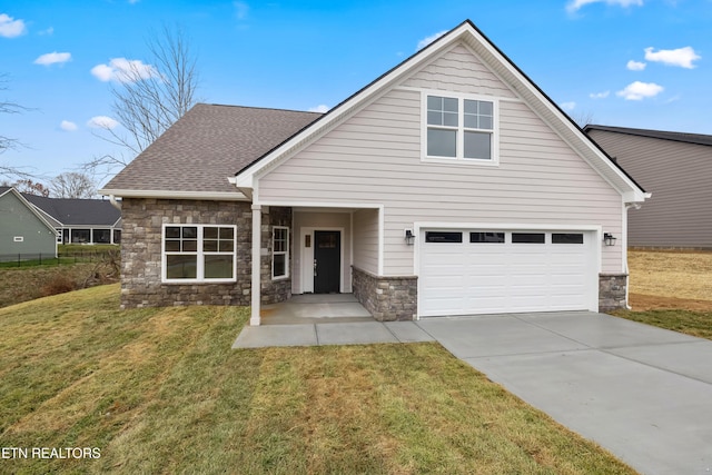 view of front of home featuring a front yard and a garage