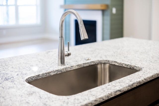 room details with light stone countertops and sink