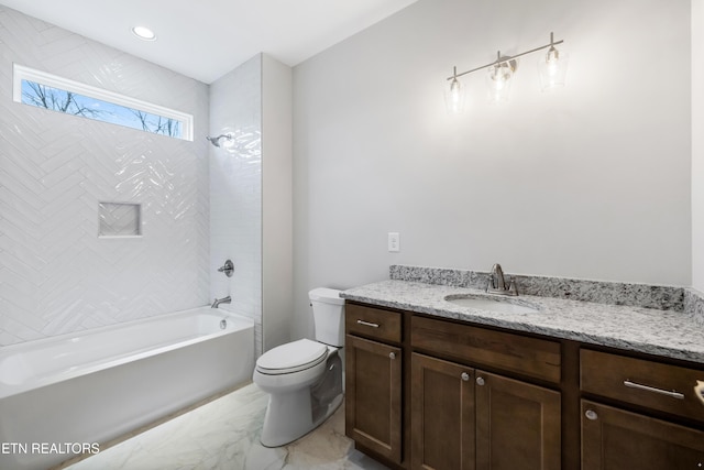 full bathroom with vanity, tiled shower / bath combo, and toilet