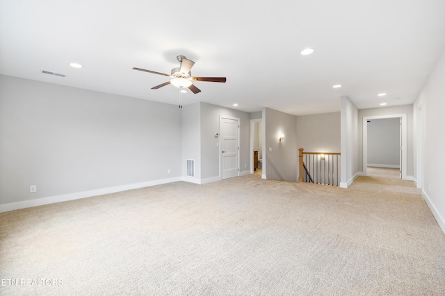 unfurnished room featuring ceiling fan and light colored carpet