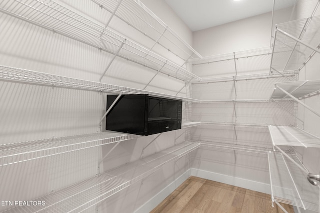 spacious closet featuring hardwood / wood-style floors