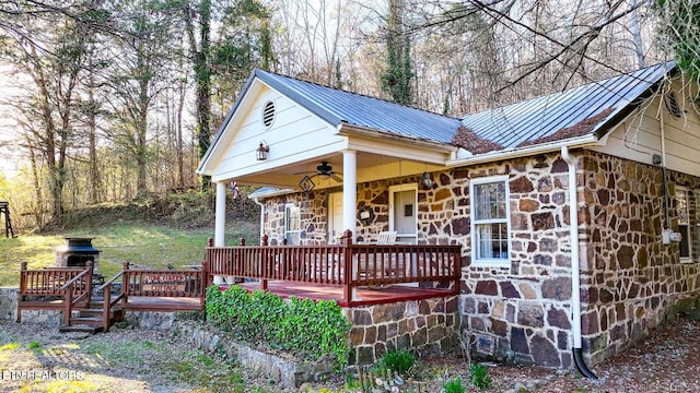 exterior space featuring covered porch, a deck, and ceiling fan