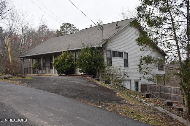 view of front of property featuring covered porch and a garage