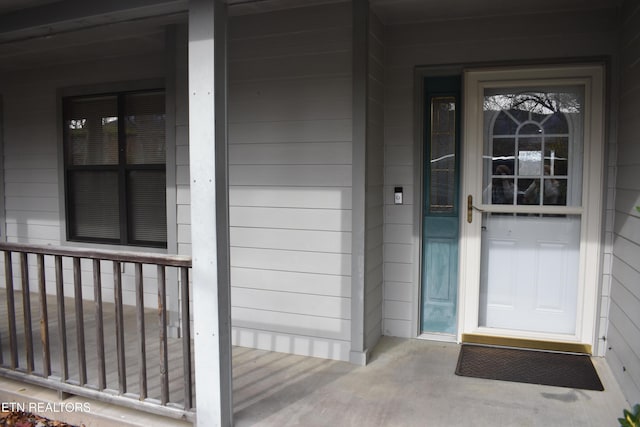 view of exterior entry featuring a porch