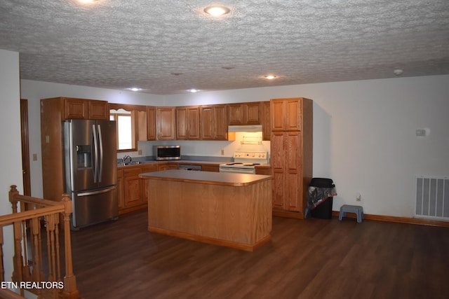 kitchen featuring a center island, dark wood-type flooring, white electric stove, a textured ceiling, and stainless steel fridge with ice dispenser