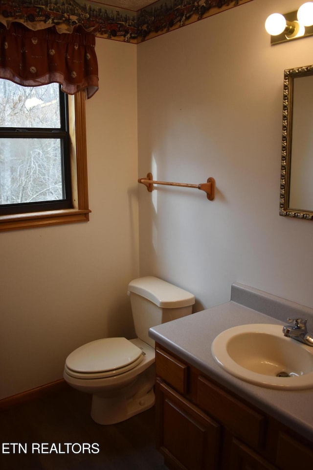 bathroom featuring vanity and toilet